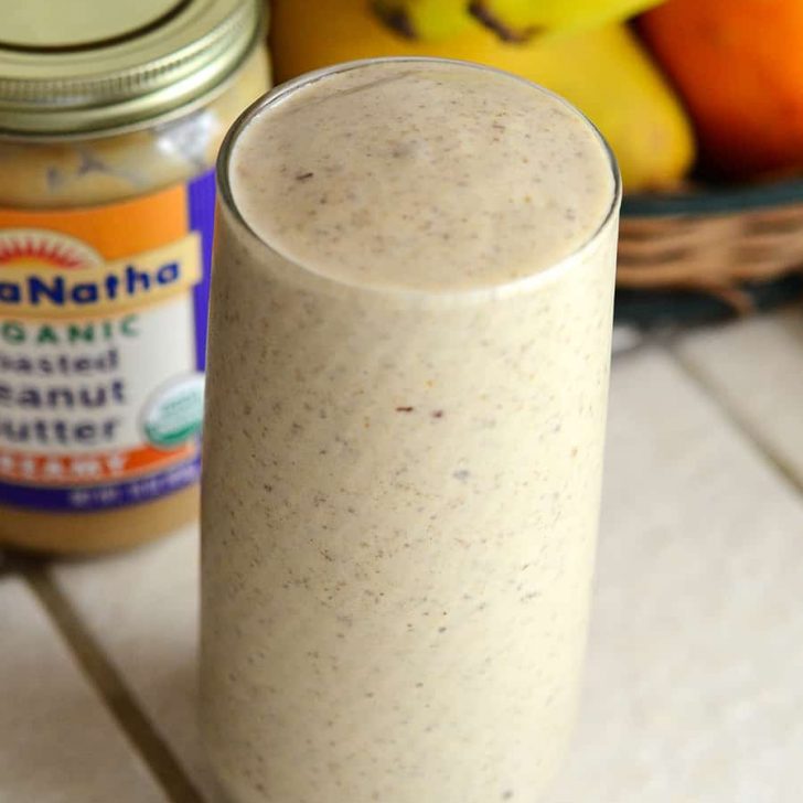 Glass filled to the brim with tan-colored Hangover Cure Smoothie