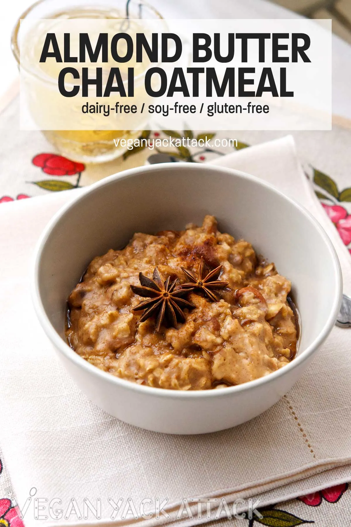 For a healthy, comforting breakfast that comes together in minutes, make this Almond Chai Oatmeal! light grey bowl of oatmeal topped with star anise, text overlay saying "almond butter chai oatmeal"