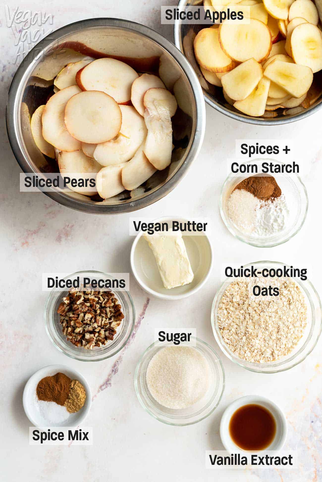 Sliced apples and pears, plus other ingredients in ramekins with text labels