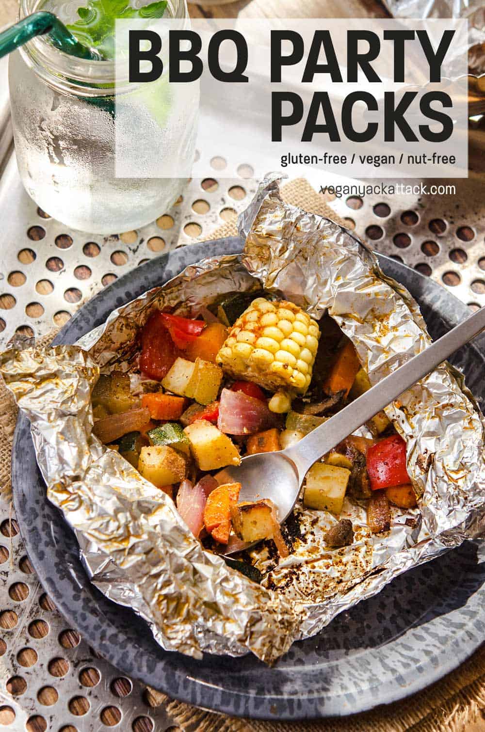 Foil, grilled, BBQ Party Pack opened up with veggies showing, being eaten with a spork