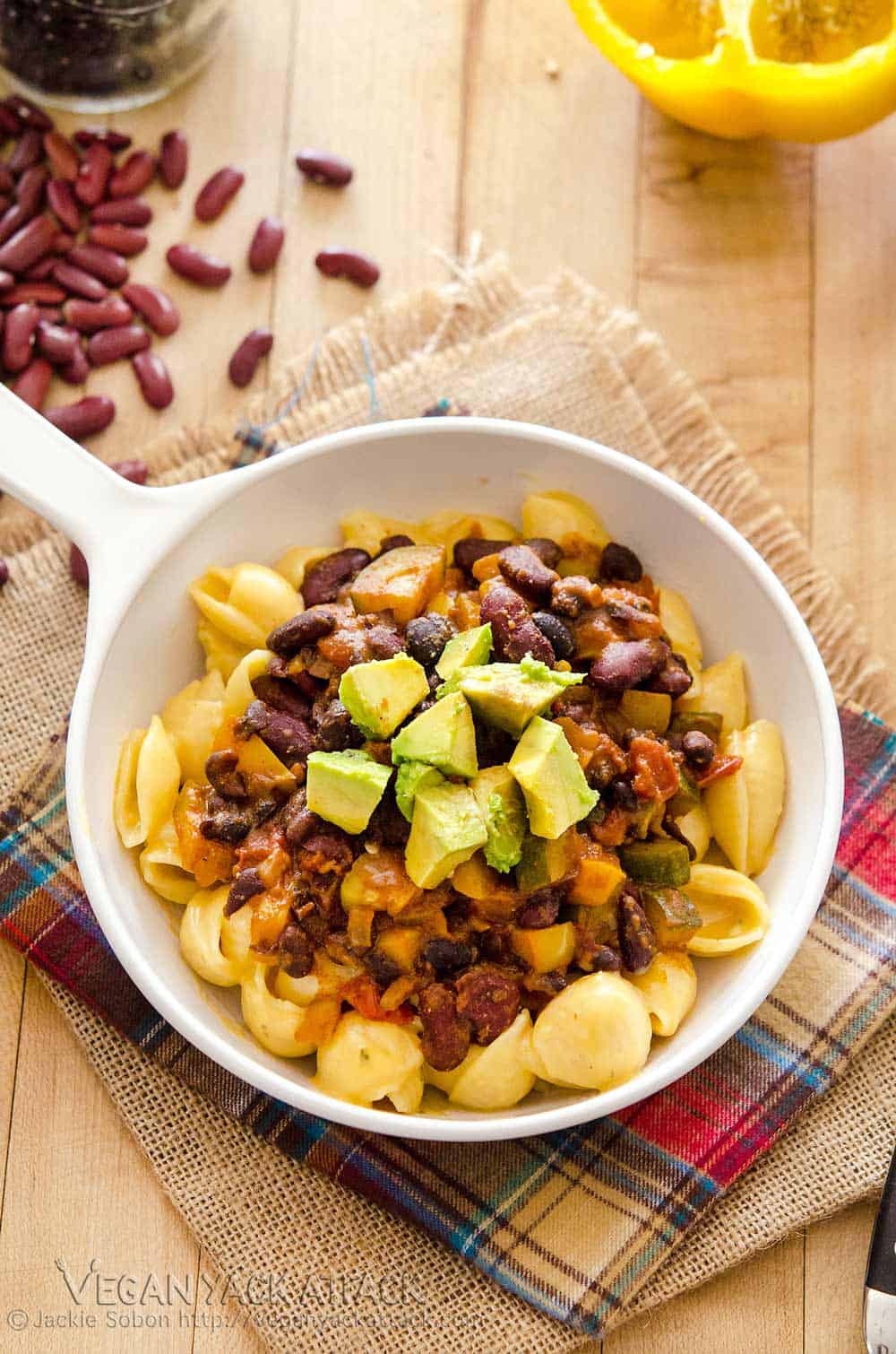 Image of Vegan Chili Mac and Cheese on linens, with loose beans in the background