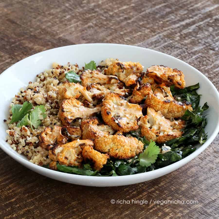 This delicious Quinoa Cauliflower bowl is filled with grains, lightly cooked greens & Sriracha Sauce, so it's healthy AND delicious! Vegan, soy-free
