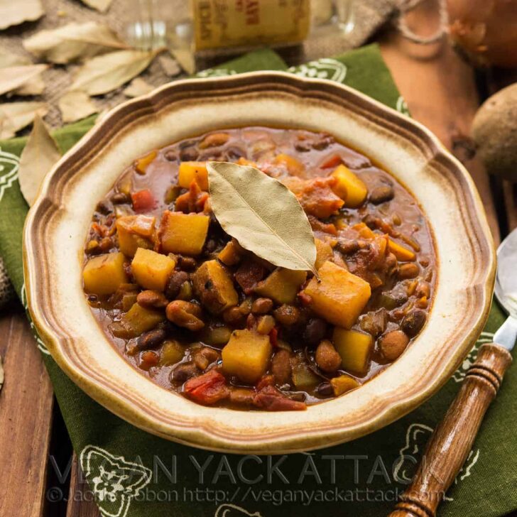 Slow Cooker Potato Curry Chili in a stoneware bowl with green linen and wood table top