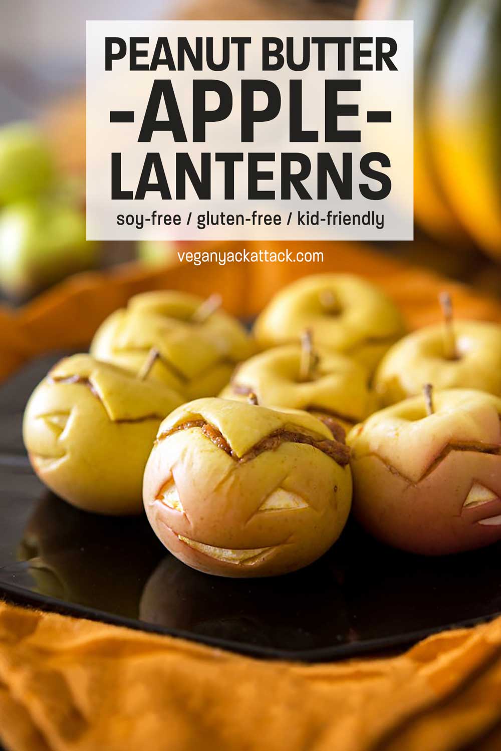 Close up of peanut butter-stuffed apples with faces and text reading "Peanut Butter Apple-Lanterns"