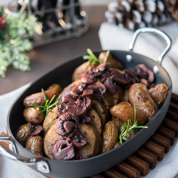 Pressure Cooker Seitan with Red Wine Mushroom Sauce in an oval baking dish with potatoes