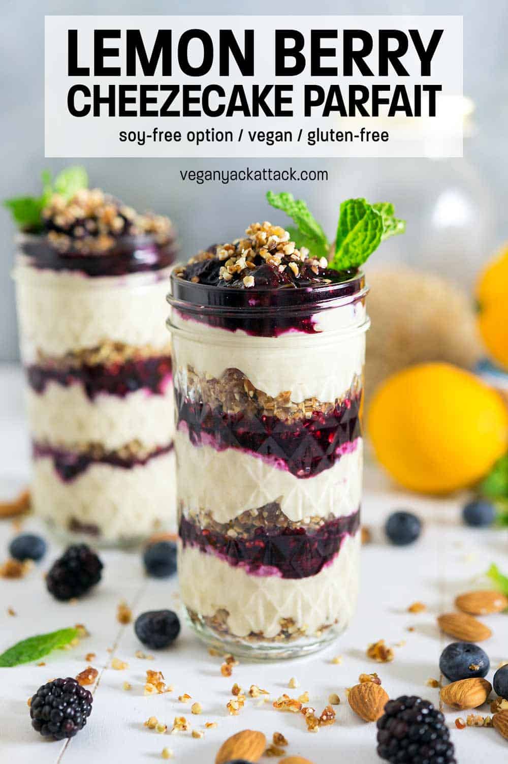 Lemon Berry Cheezecake Parfait stacked in glass jars on a white table