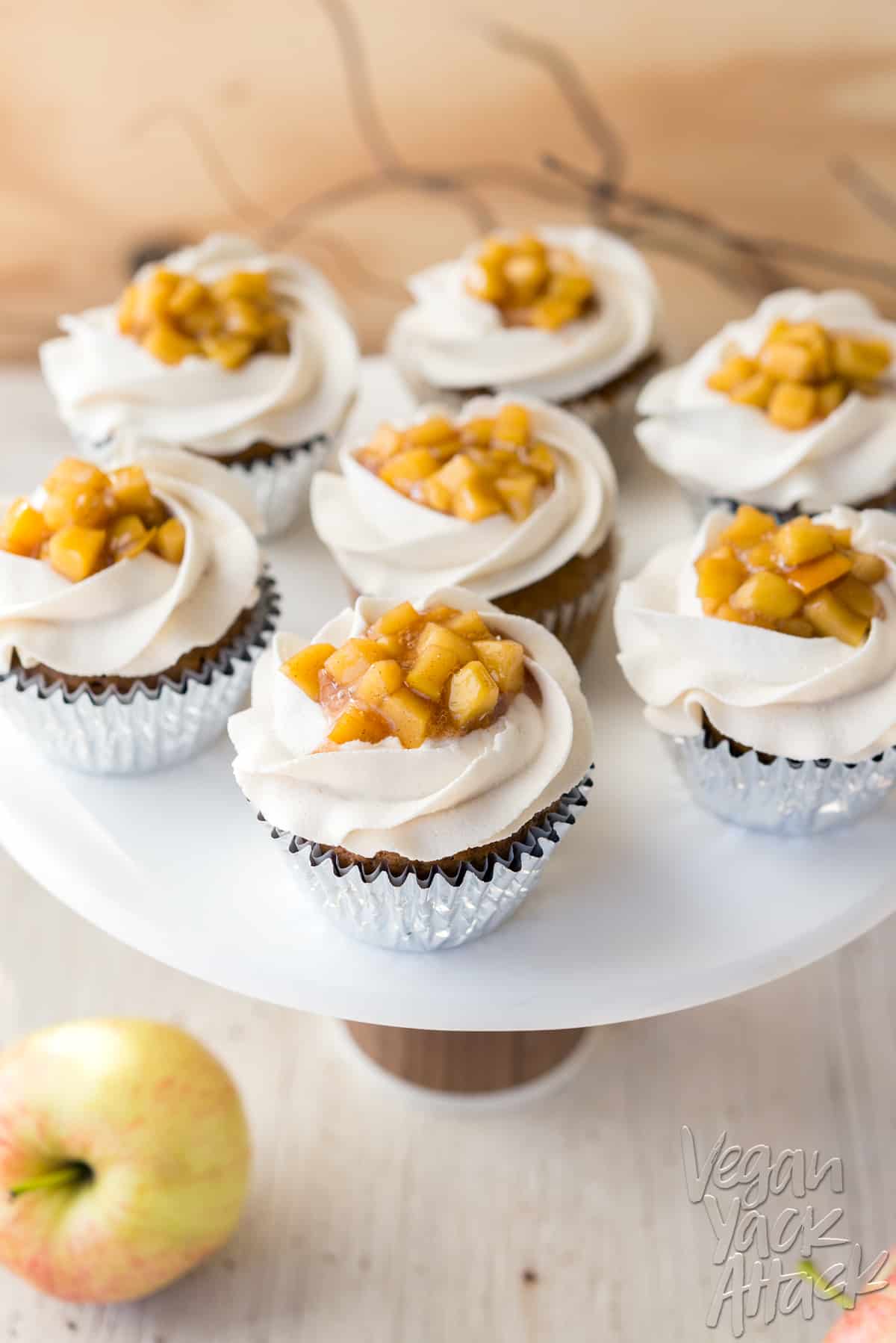 Image of cupcakes on a cake stand with apple pie filling in the middle of vanilla frosting