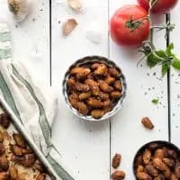 Image of pizza-roasted almonds in two small bowls on a white table