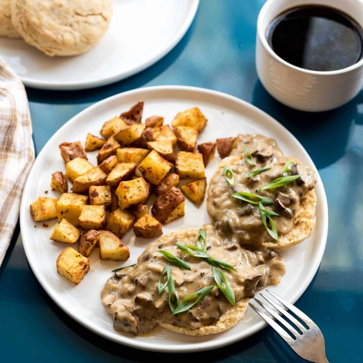 Rich, comforting gravy, on top of fluffy, flaky, buttery vegan biscuits? You got it! This recipe for vegan biscuits and gravy will become a staple in your brunch menu, for many mornings to come. #vegan #brunch #veganyackattack