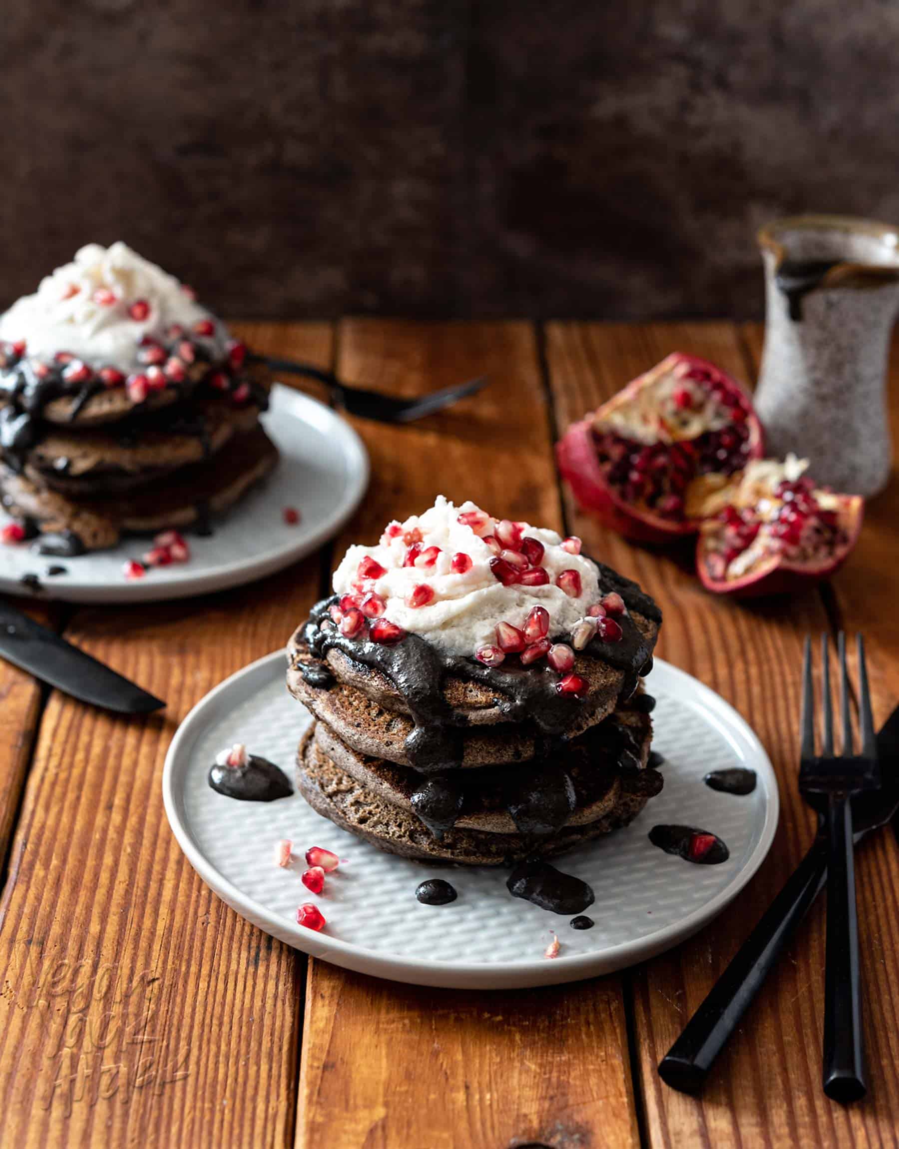These Spooky Buckwheat Pancakes are eye-catching and delicious! Fluffy pancakes drizzled with a sweet black sesame sauce and topped with pomegranates, what more could you want? #Vegan #nutfree #glutenfreeoption #soyfree #halloween #veganrecipes