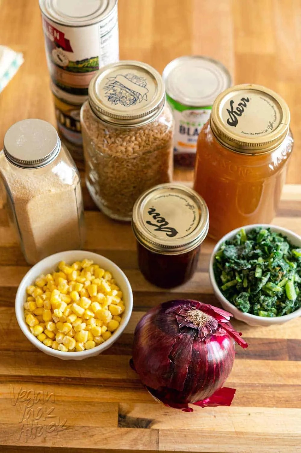 Image of ingredients: red onion, corn, kale, vegetable broth, grains and beans