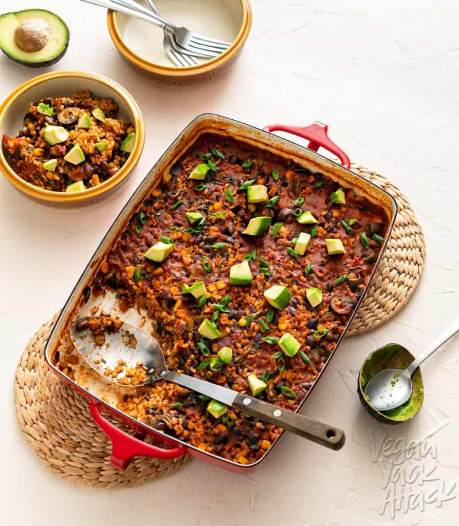 Image of chipotle brown rice bake in a red casserole dish on a beige background