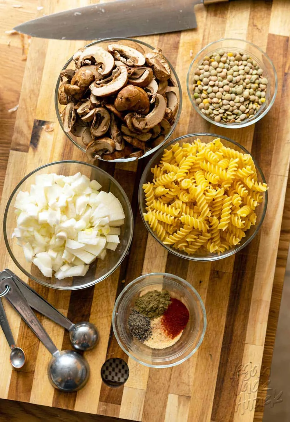 Image of prepped mise en place, on a cutting board, for pasta dish