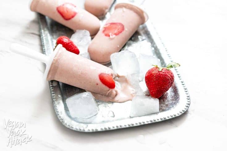 Strawberry Oat Milk Popsicles on a metal platter with ice cubes