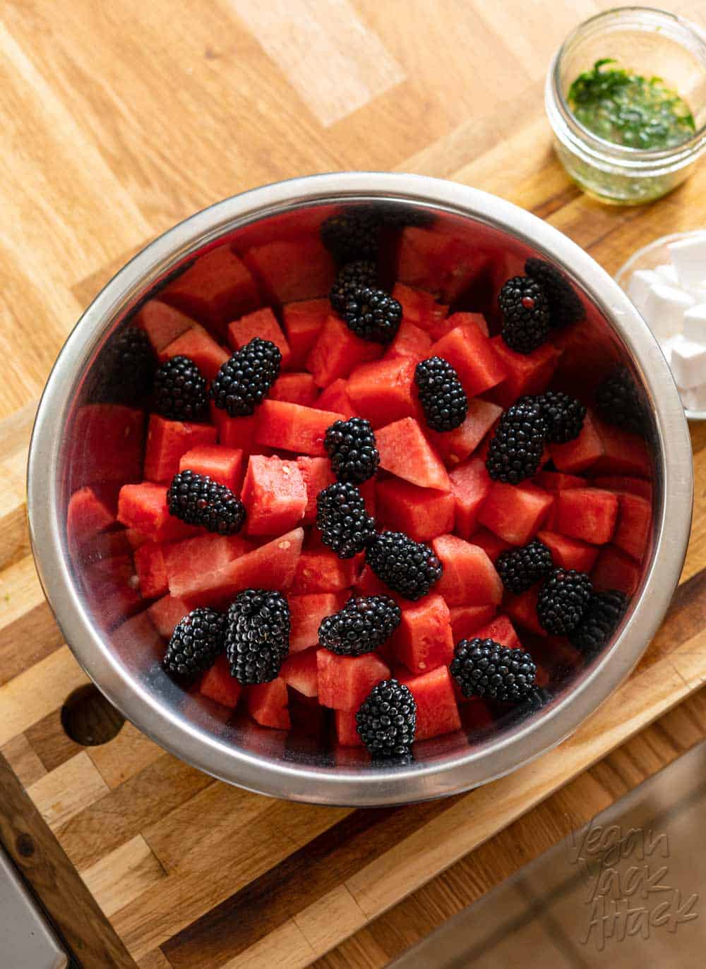 Large metal bowl filled with cubed watermelon and blackberries