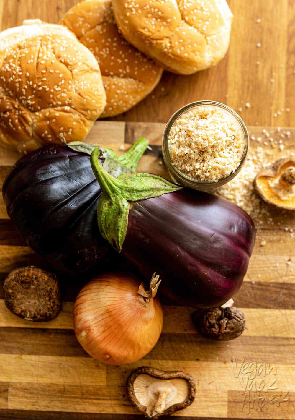 Eggplants, onion, shiitake mushrooms, and panko crumbs on a cutting board