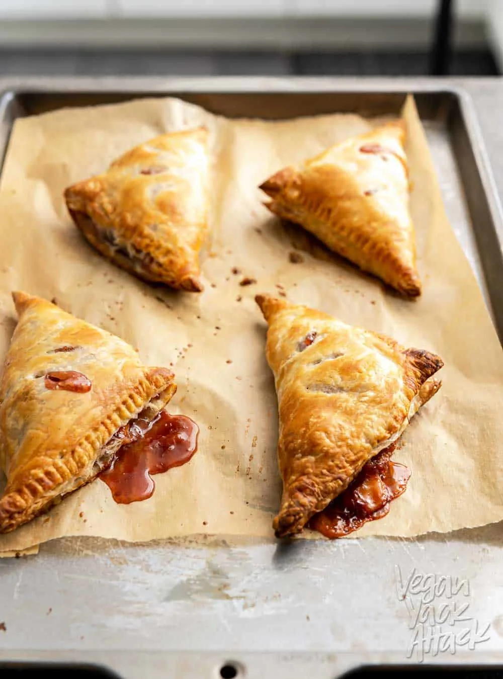 peach puff pastry turnovers fresh out of the oven on a sheet
