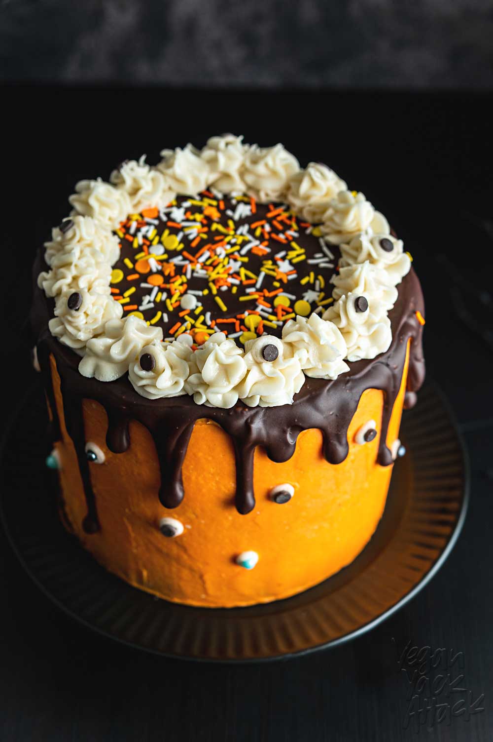 Orange frosting covered a marbled layer cake, with sprinkles