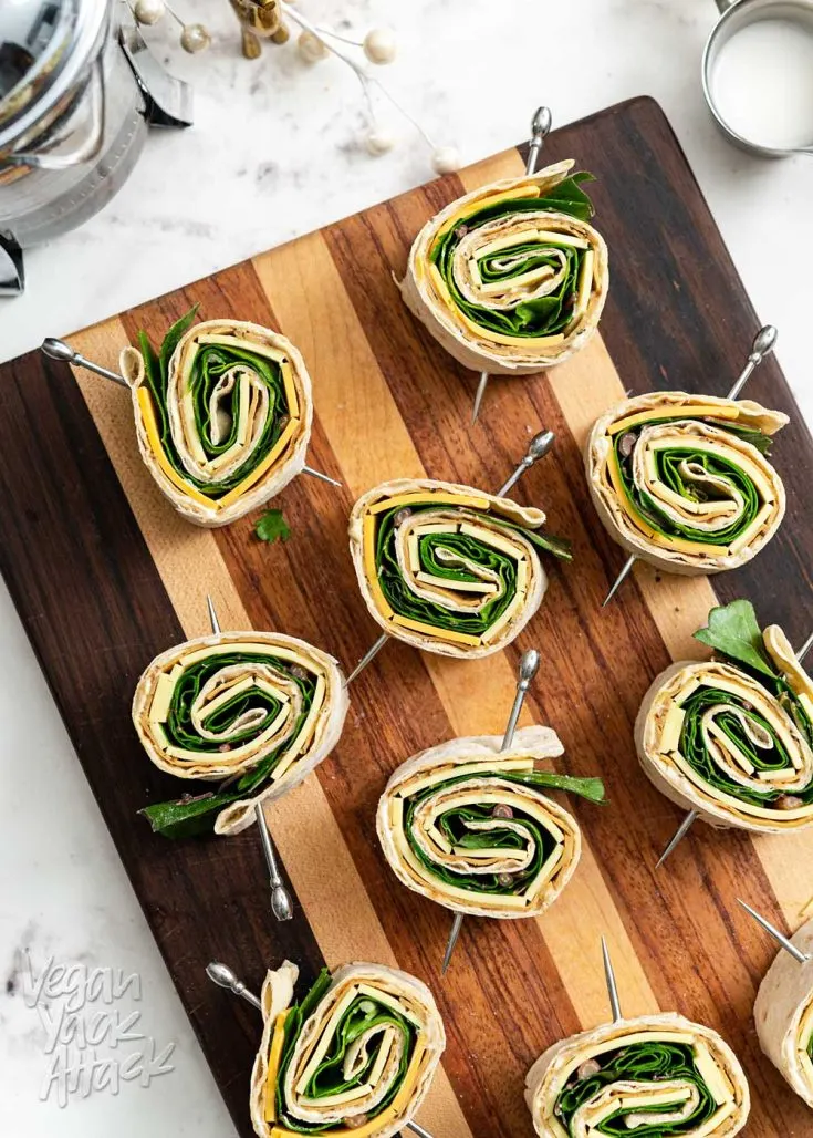 Cutting board with multiple plant-based pinwheels facing up