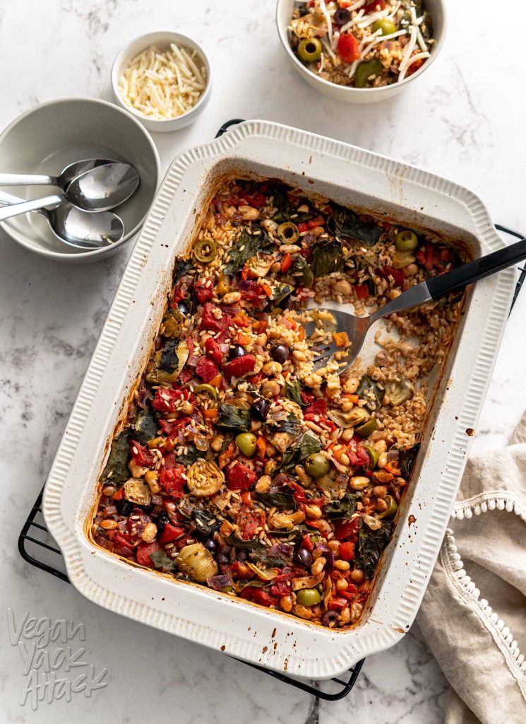 Large casserole dish containing veggie-filled rice bake on a marble table