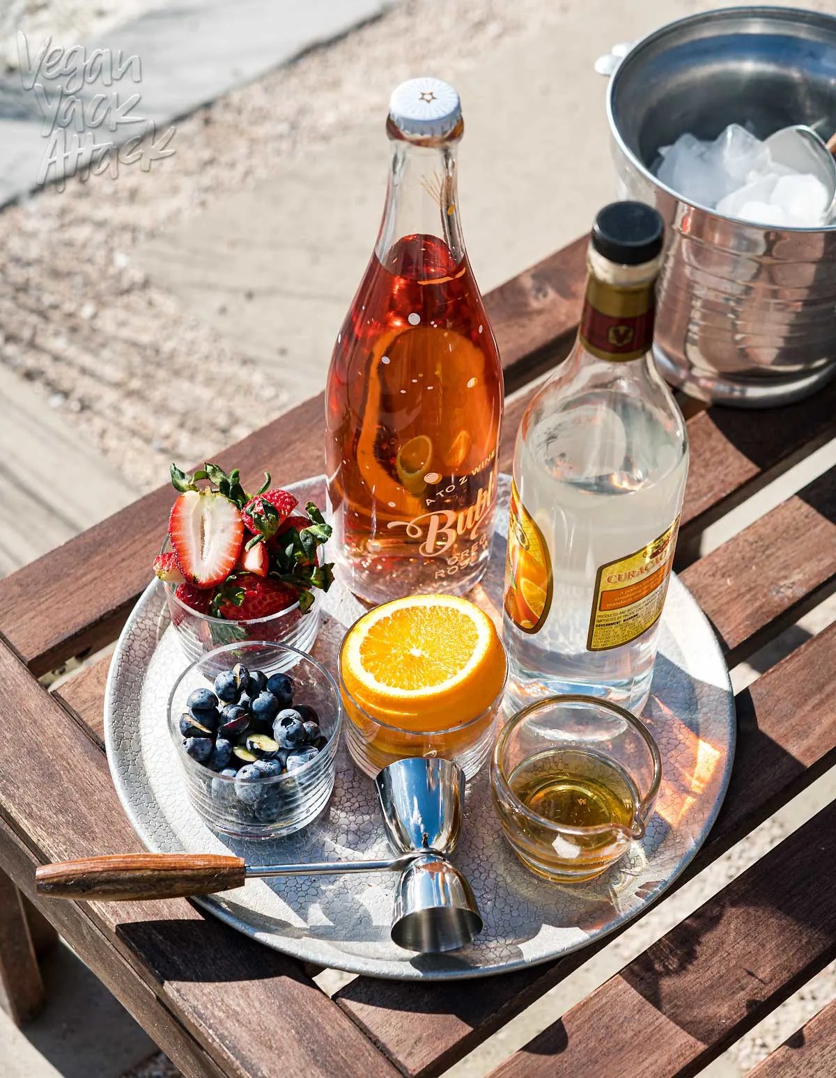 Wine, liqueur, and fruit on a metal tray