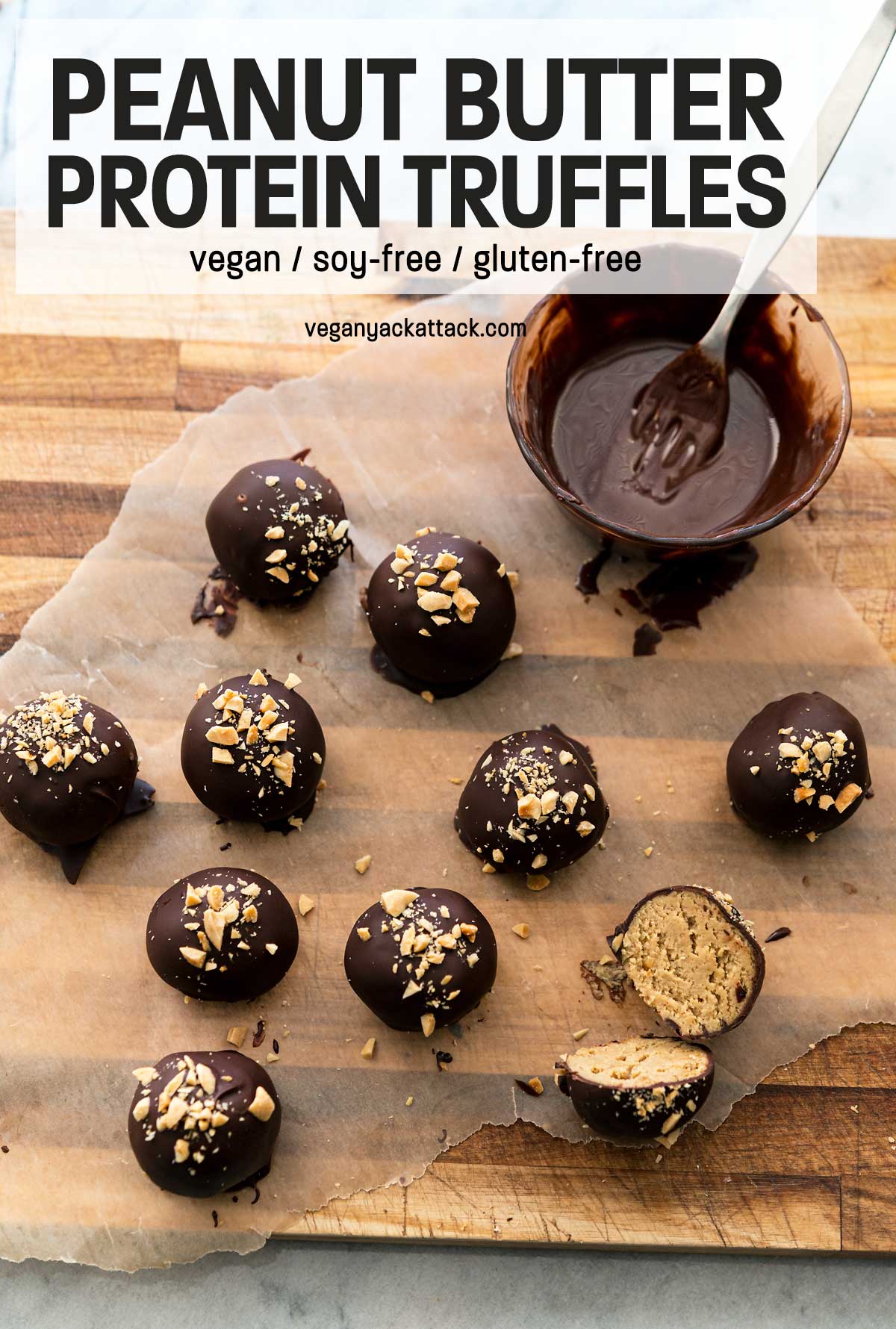 Chocolate-covered peanut butter bites on a cutting board next to melted chocolate