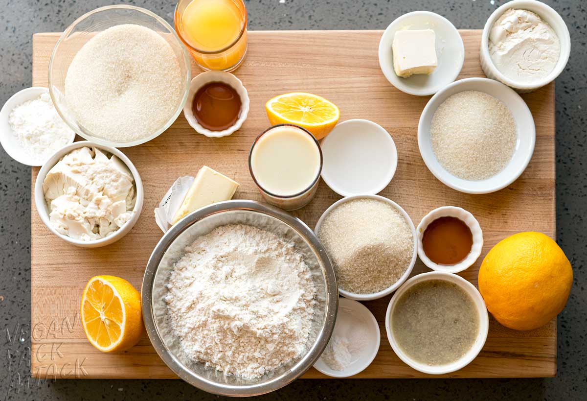 Ramekins full of baking ingredients on a wooden cutting board