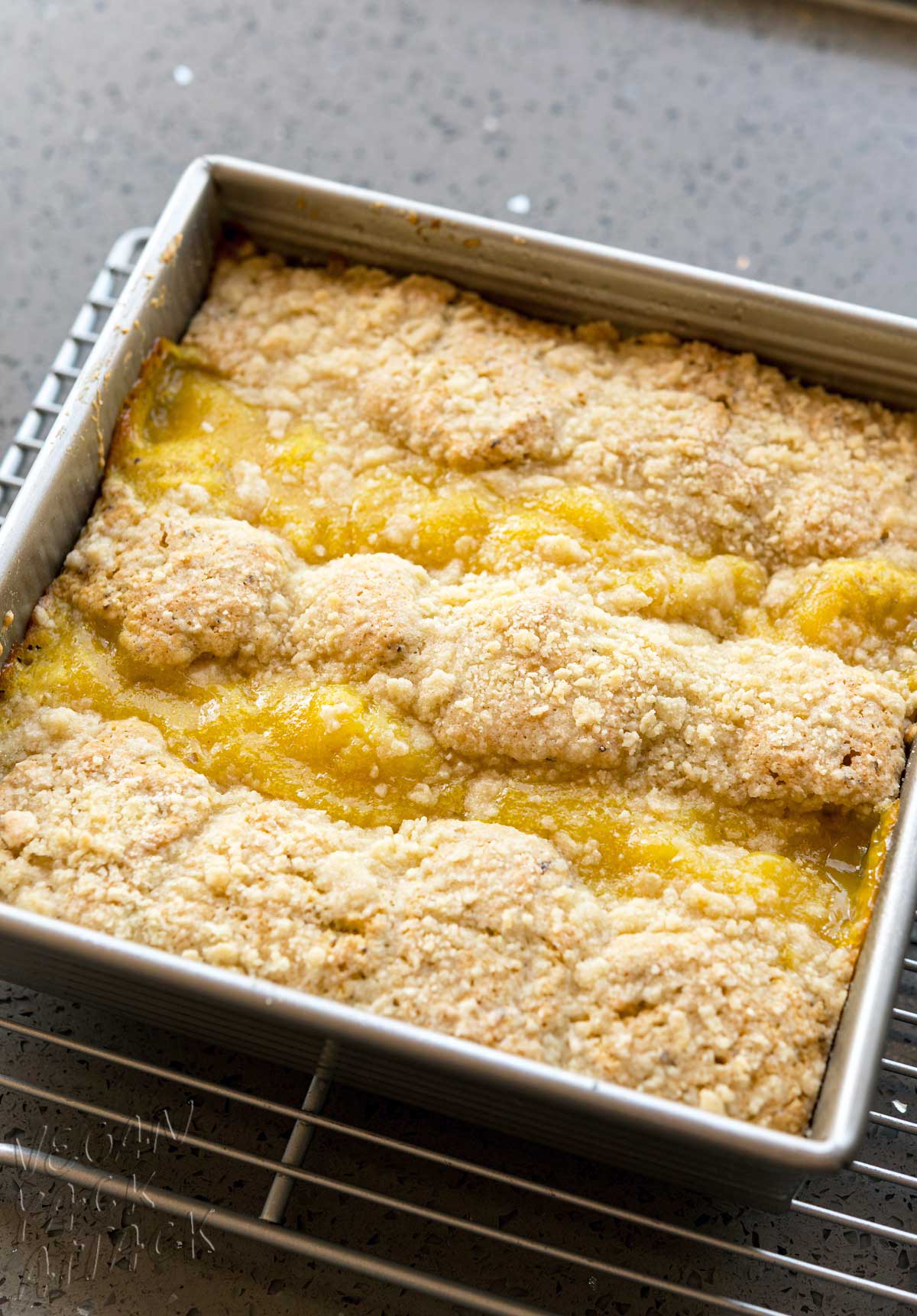 Baked lemon curd coffee cake on a cooling rack