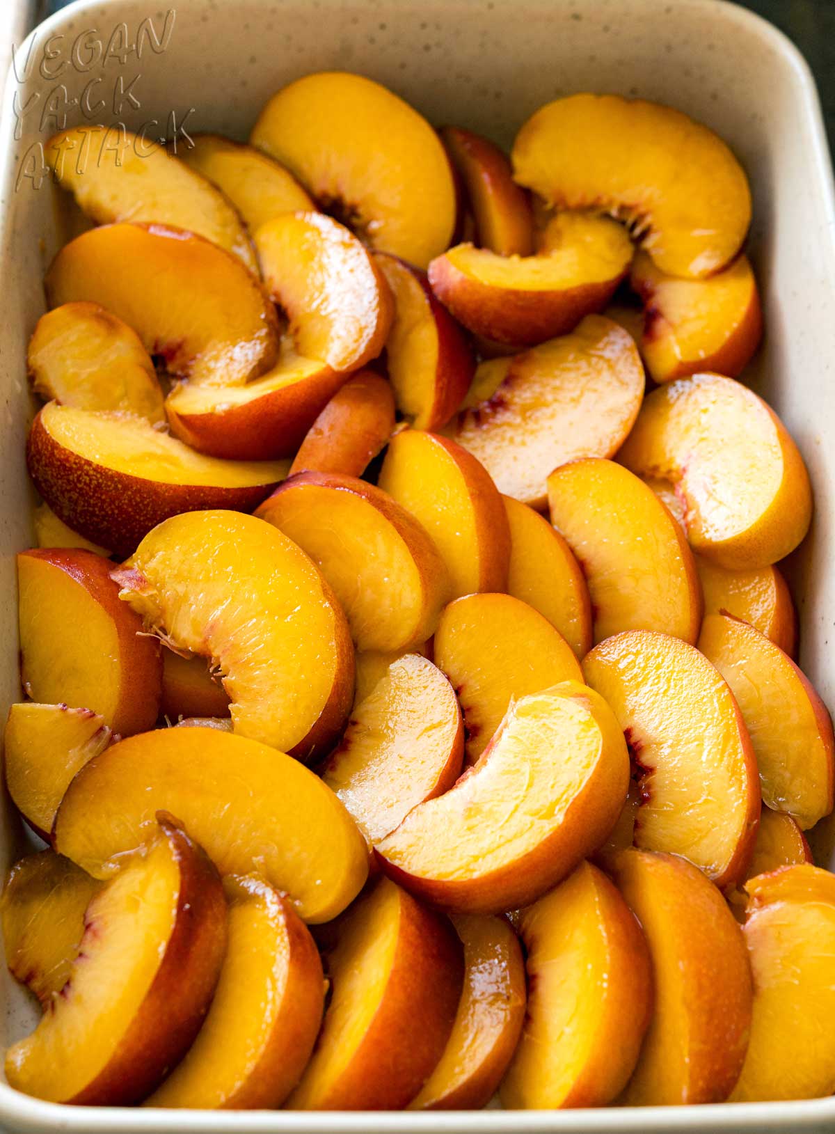 peach slices arranged in a baking dish